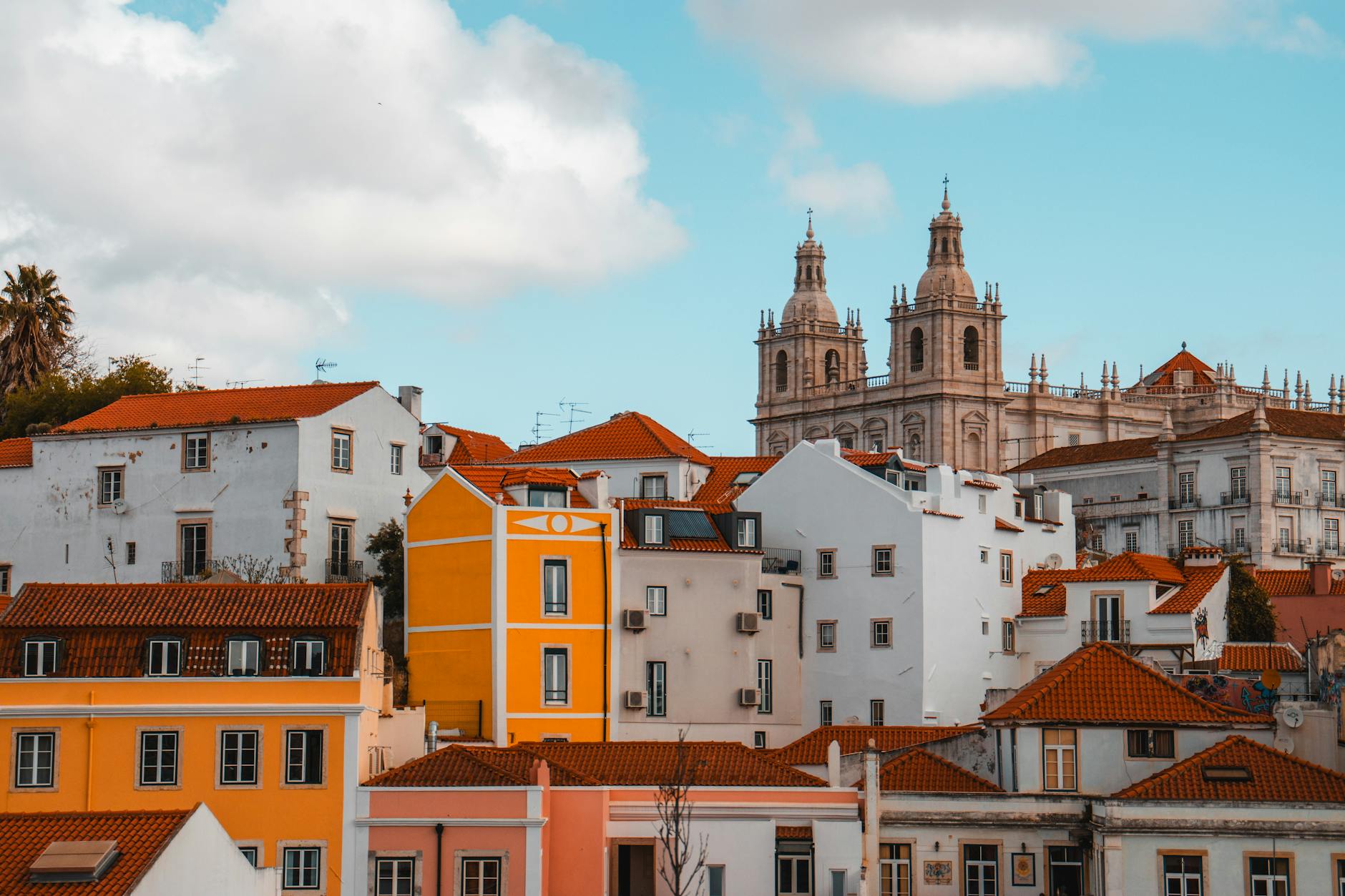 Kolorowe dachy Lizbony z wieżami kościołów w słoneczny dzień